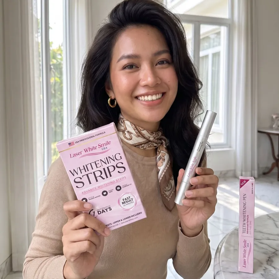 Woman holding the whitening pen and a box of whitening strips